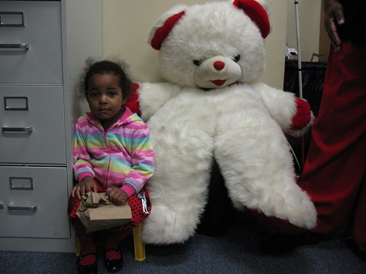 A little girl and the Christmas Teddy Bear